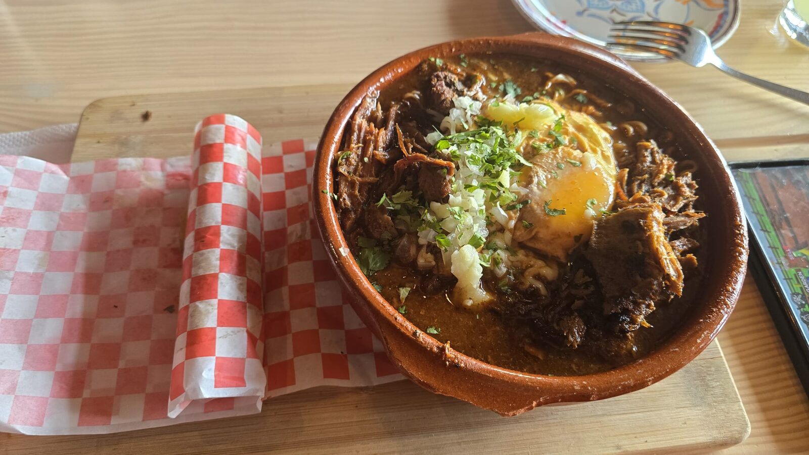 Traditional Dominican stew served in a clay bowl on a wooden board